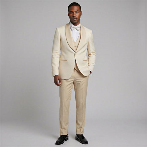 Man wearing a ivory pattern tuxedo with a white shirt and bow tie on a gray background