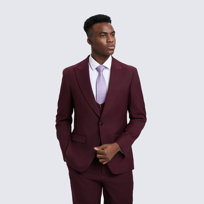 man wearing burgundy suit at wedding 