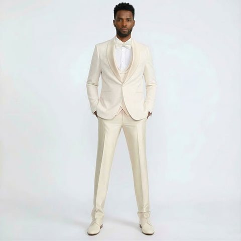 Man wearing a ivory tuxedo with a white shirt on a light gray background