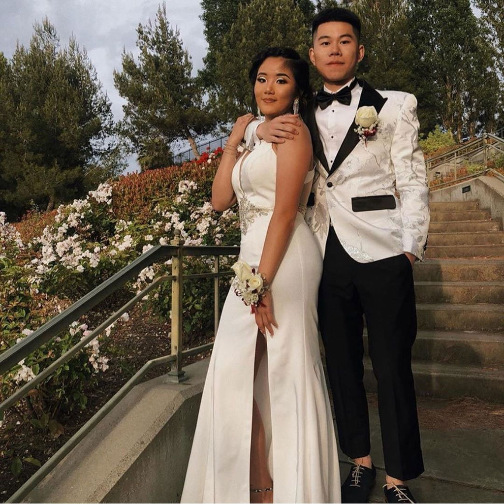 prom couple with guy wearing white prom tuxedo jacket