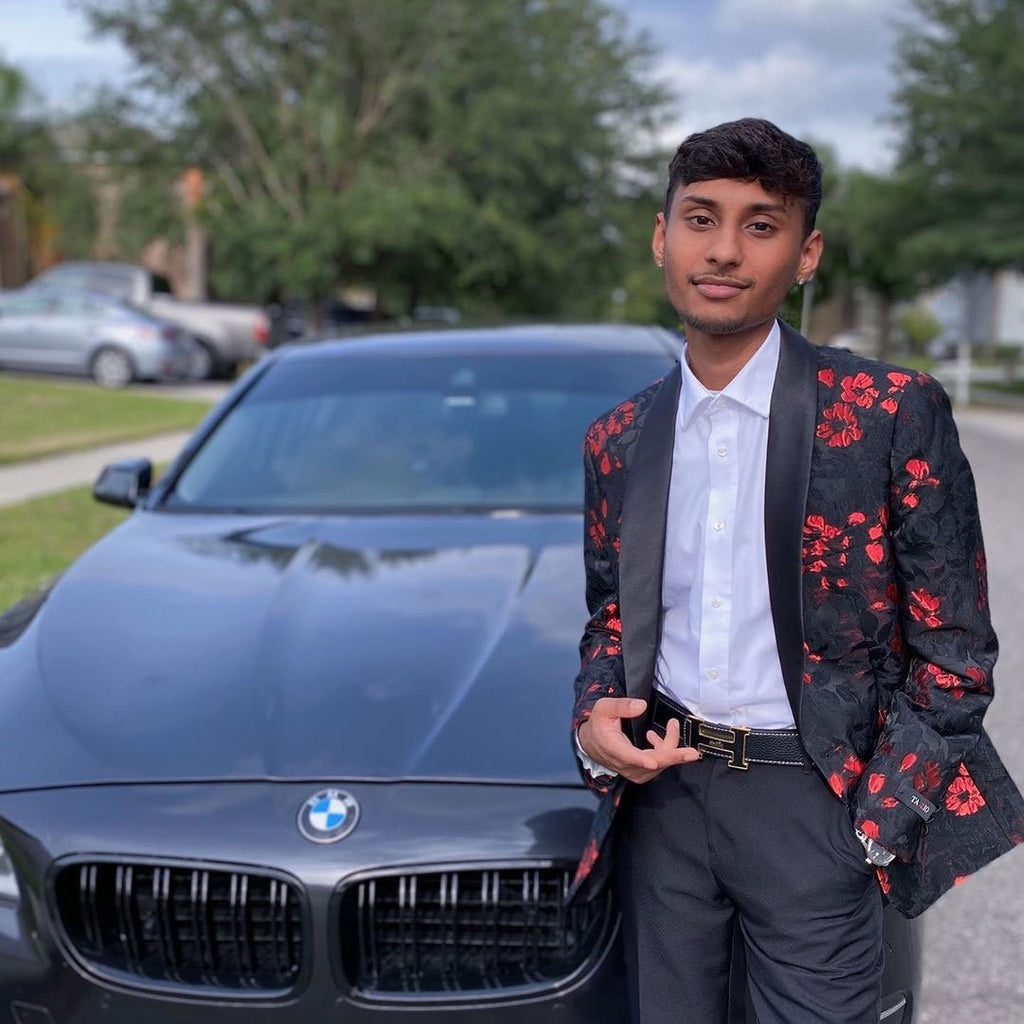 Guy wearing prom suit blazer in front of car