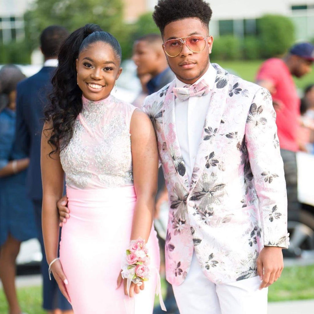 Prom couple with guy wearing pink prom suit blazer.