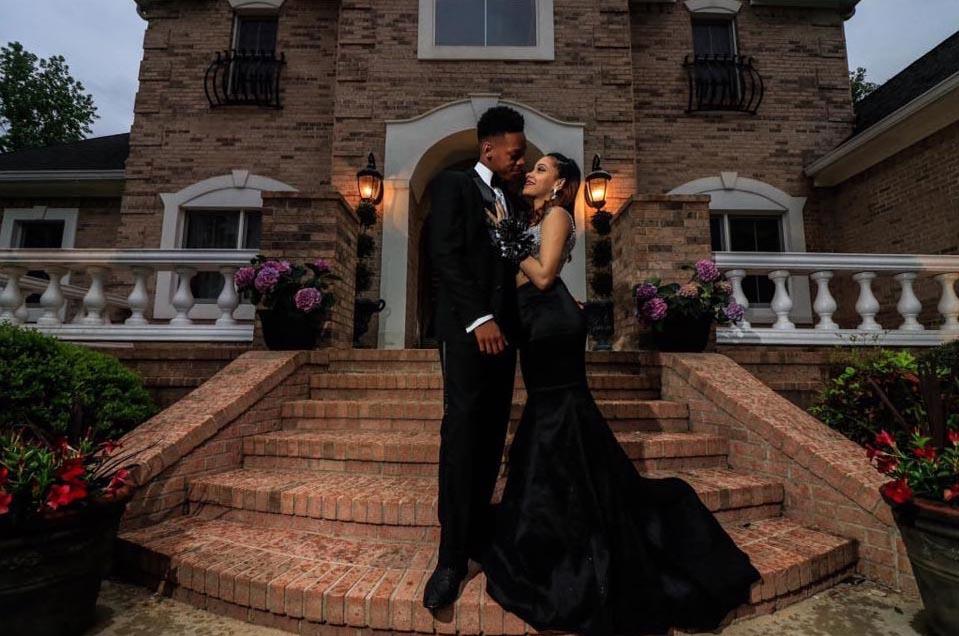 prom couple with guy wearing black prom tuxedo