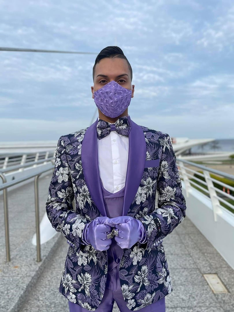 guy wearing purple prom suit tuxedo with gloves and mask.