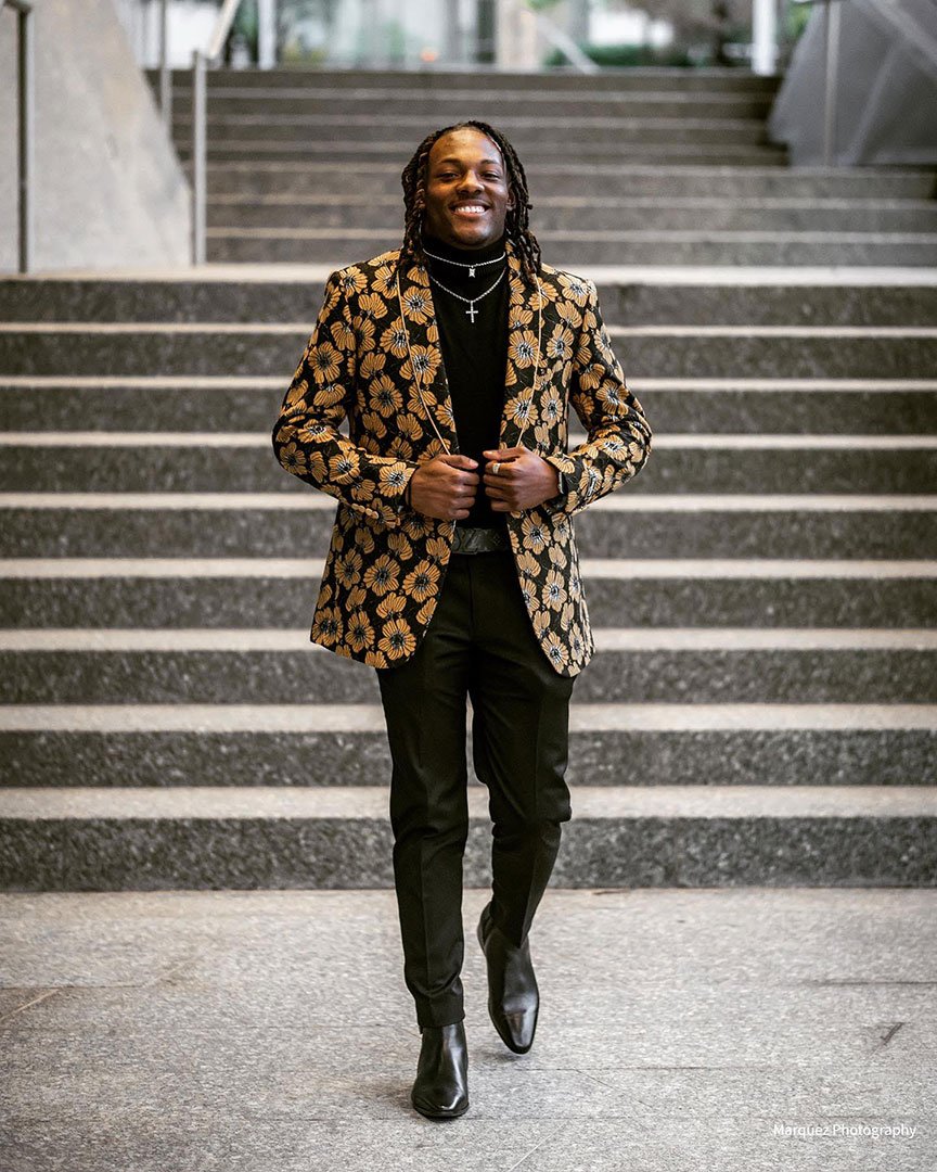 guy wearing black and gold prom suit jacket